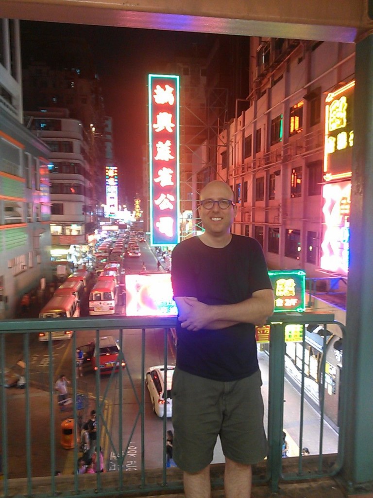 Me in Sham Shui Po, posing in front of a dozen or so city busses